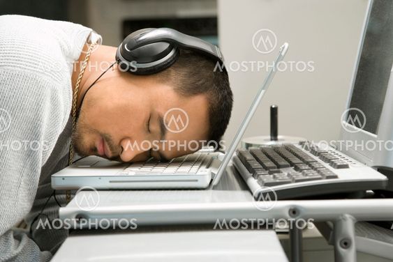Man napping on laptop.