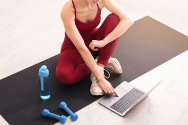 Quarantine sports. Unrecognizable girl selecting online...