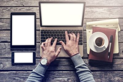 Top view man working with a laptop and tablet pc....