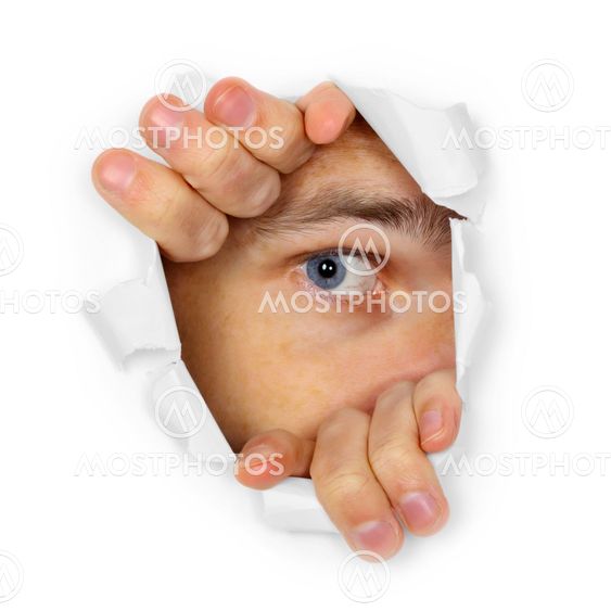 Man watches through a hole