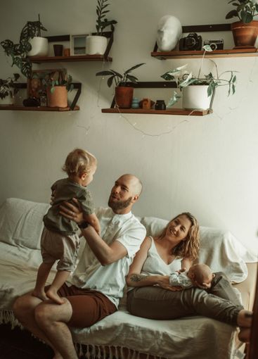 Family, playing and parents with baby and toddler on a...