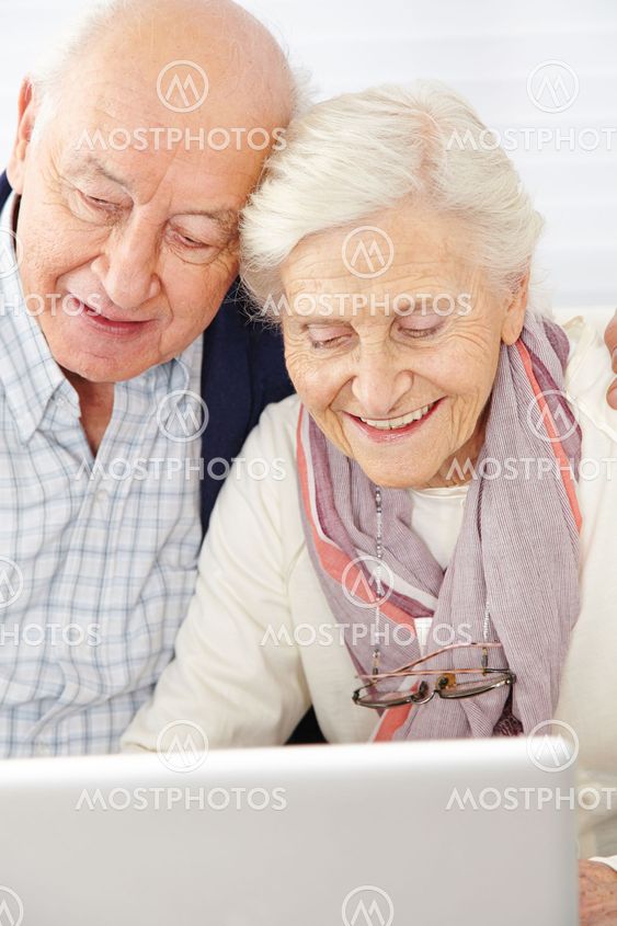 Senior couple using social media with computer