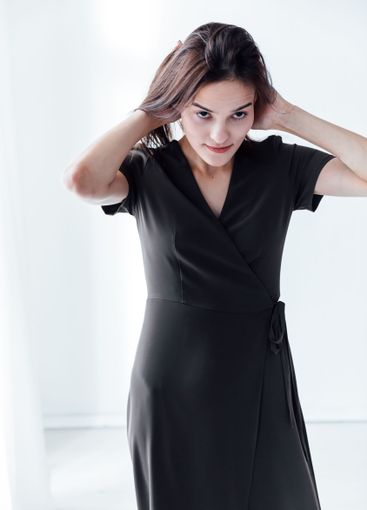 Beautiful fashionable brunette woman in green summer...