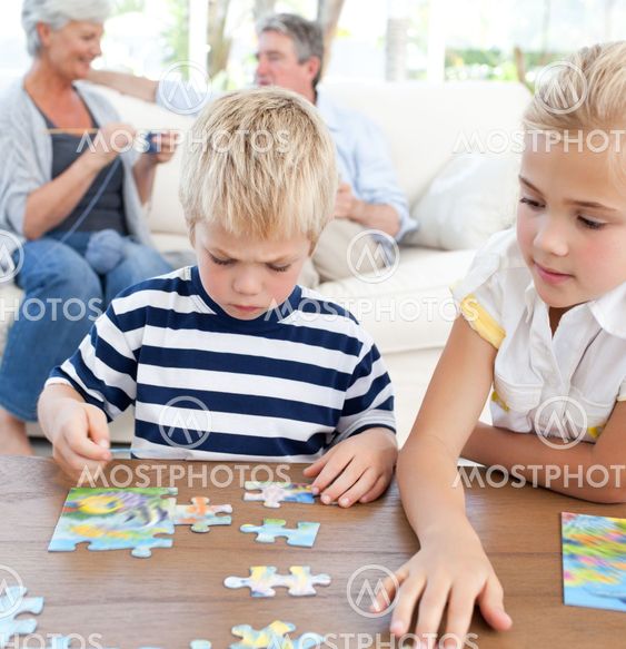Children playing puzzle in the living room