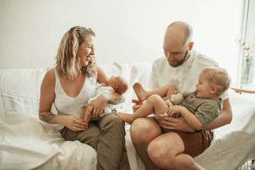 Parents, children and fun with a family on the sofa in...