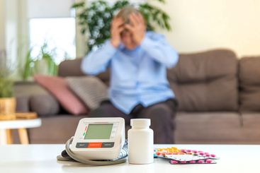 An old woman measures her blood pressure. Selective focus.