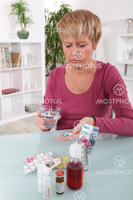 Grumpy woman taking her pills