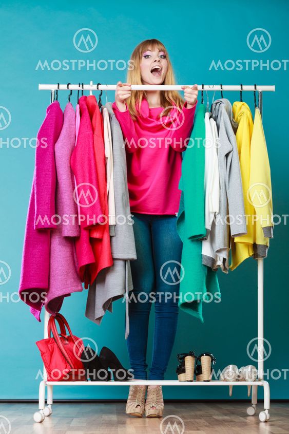 Woman choosing clothes to wear in mall or wardrobe