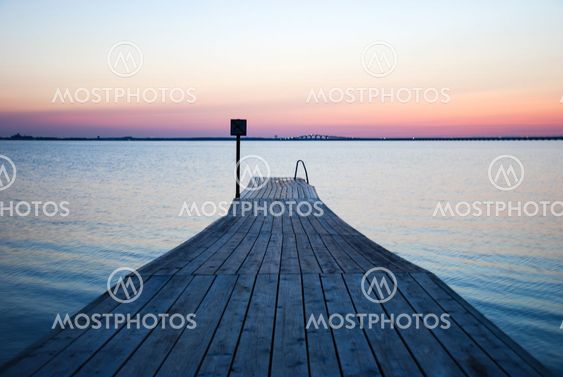 Wooden bath pier at soft colored sunset