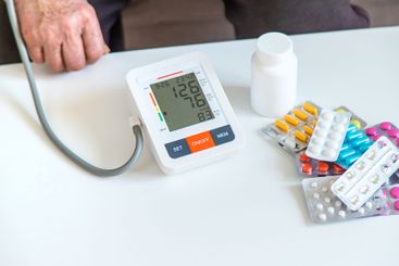 An old woman measures her blood pressure. Selective focus.