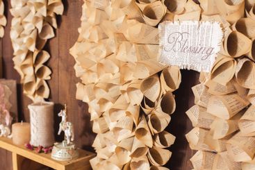Decorative wall made of folded book pages and a sign...
