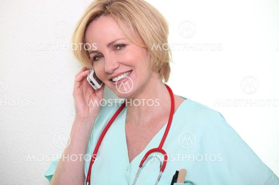 Female nurse speaking on mobile telephone