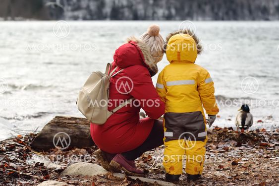 Family with little son enjoy view of lake Alpsee,...