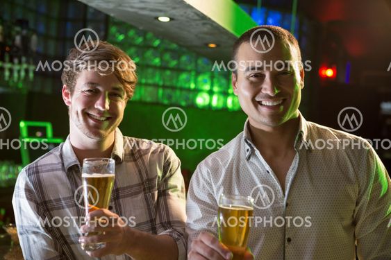 Portrait of two men having beer at bar