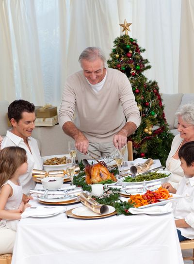 Family celebrating Christmas dinner with turkey at home
