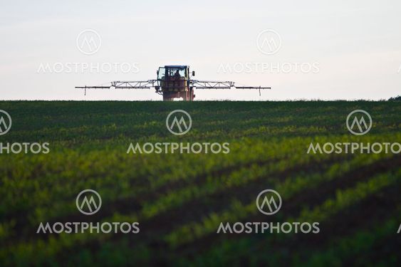 tractor with pesticide on field