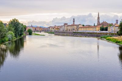 Daylight cloudy day view to Arno river with reflections