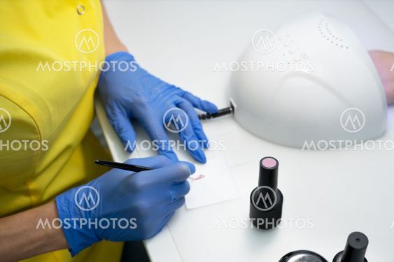 Nail care. Manicure in a manicure. the salon. The master...