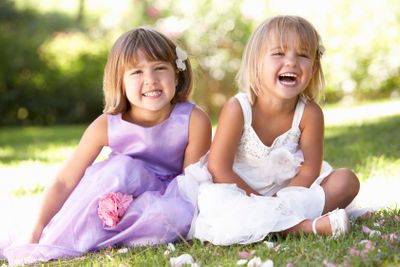 Two young girls posing in park