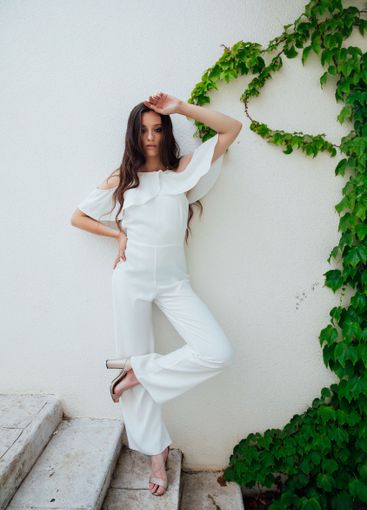 Beautiful fashionable brunette woman in white suit...