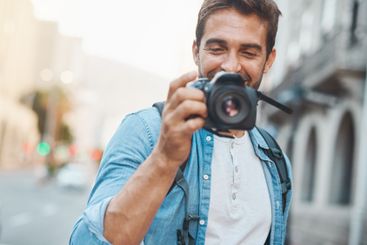 Camera, city and tourism with photographer man outdoor...