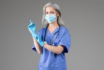 Middle aged lady doctor preparing for examination with...