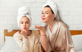 Full length portrait of beautiful young mother and her...