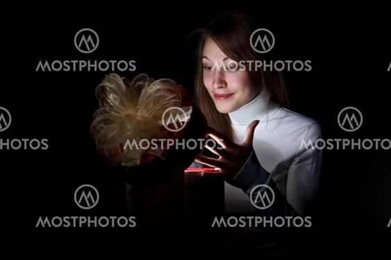Young woman reading a magic book