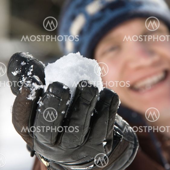 Teenager holding a snowball.