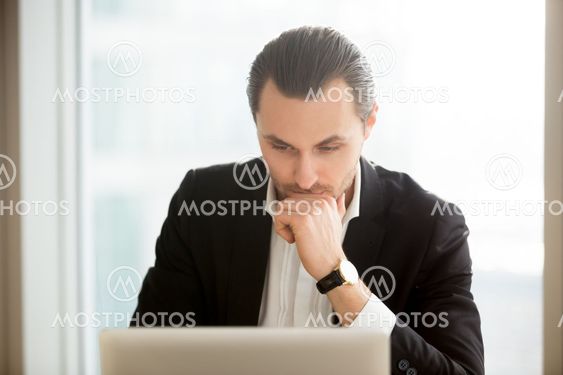 Focused businessman searching solution in Internet