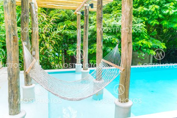 White hammocks in Luxury swimming pool .