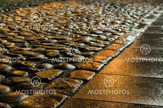 Wet shiny block pavement at night