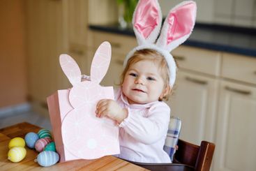 Cute little toddler girl wearing Easter bunny ears...