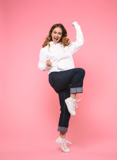 Full length image of Cheerful screaming blonde woman