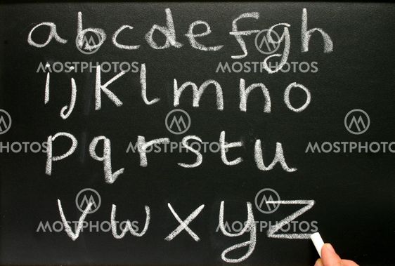 Writing the alphabet on a teacher?s blackboard.