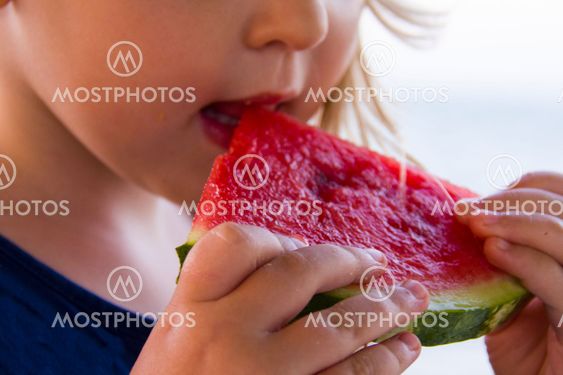 face of a girl holding watermelon outdoors