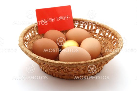 basket with usual chicken egg and golden egg on white background