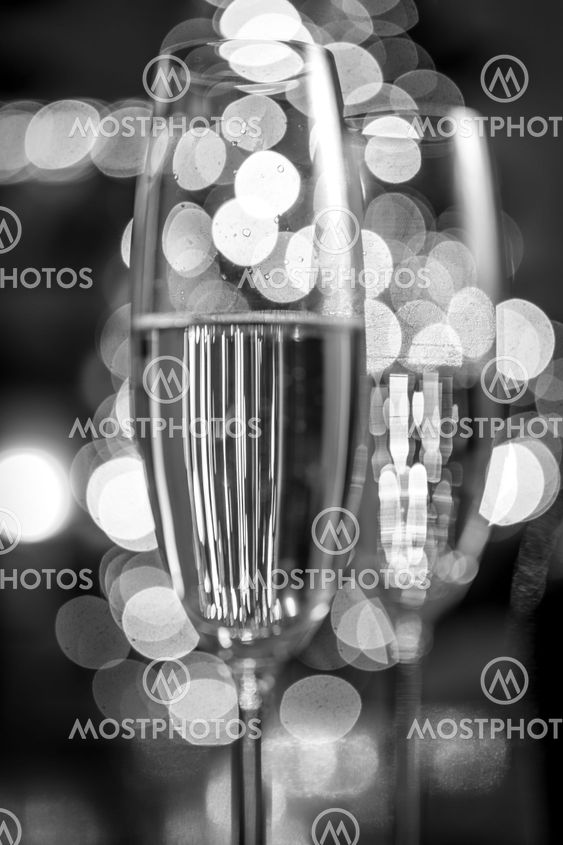 two champagne glasses on background of Christmas lights