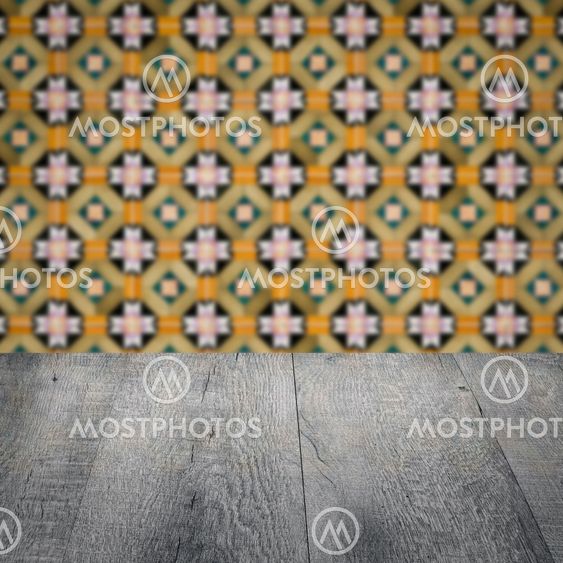 Wood table top and blur vintage ceramic tile pattern wall