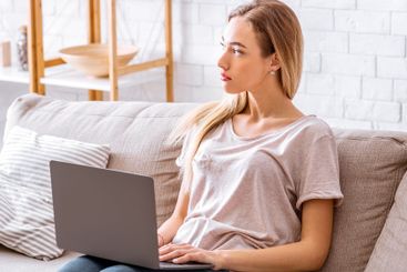 Woman with laptop working remote at covid-19 quarantine