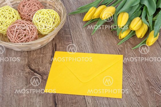 Envelope and tulips on a wooden background