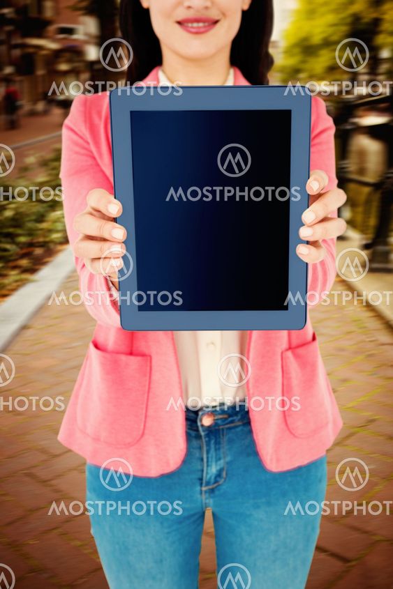 Composite image of elegant brunette using tablet