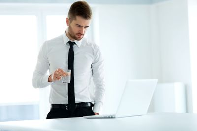 Business Man Works on his Computer at the Office