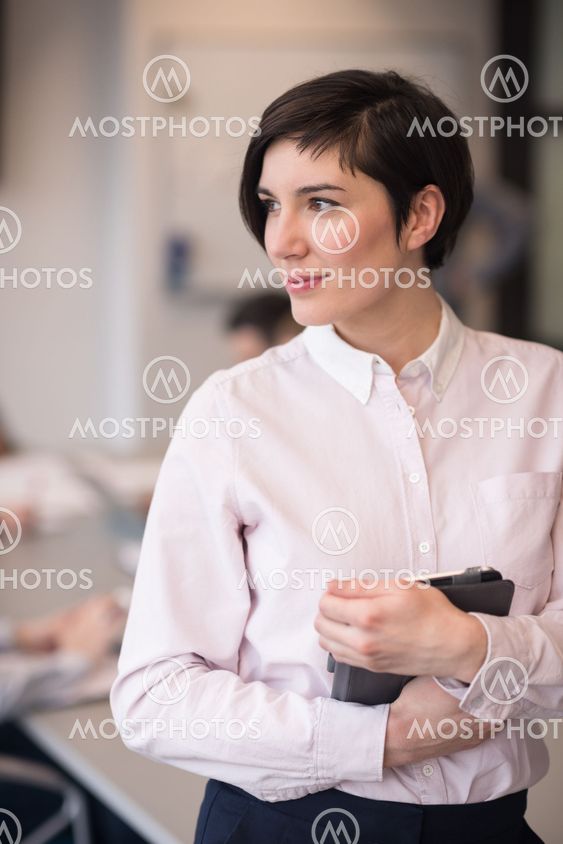 hispanic businesswoman with tablet at meeting room