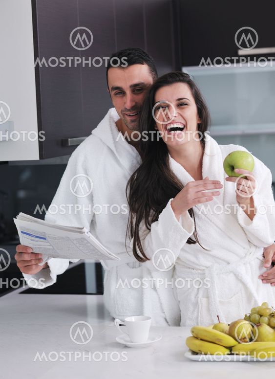 young couple have fun in modern kitchen