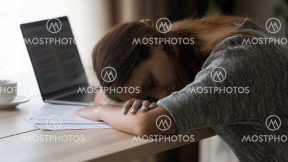 Close up exhausted unmotivated young woman sleeping at...
