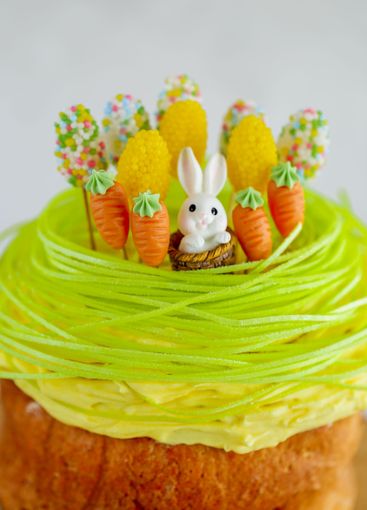 Easter baked goods with sugar decor. Bunny cake with...
