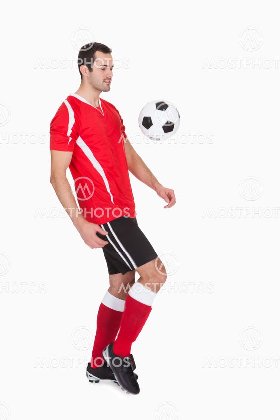 Professional soccer player kicking ball