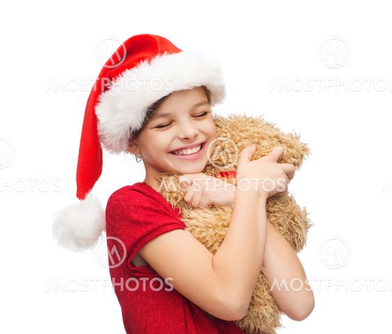 smiling girl in santa helper hat with teddy bear
