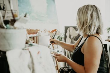 Art, color and painting on canvas, woman in home studio...